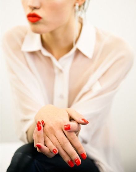 with bright nails and lips